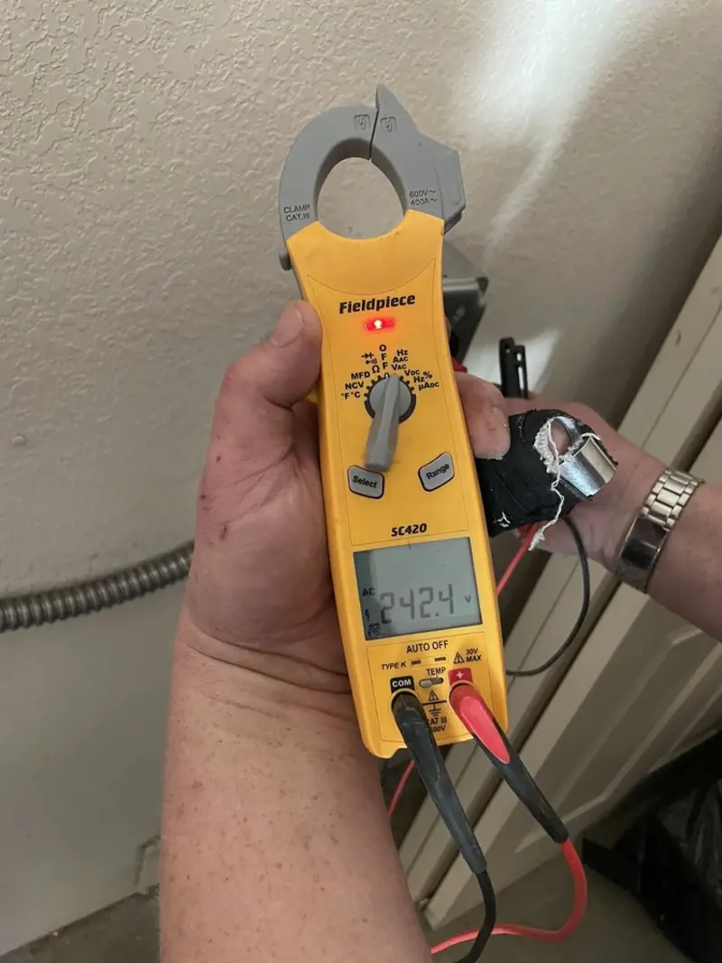 Voltage testing with clamp meter during Whole House Surge Protector in Clinton